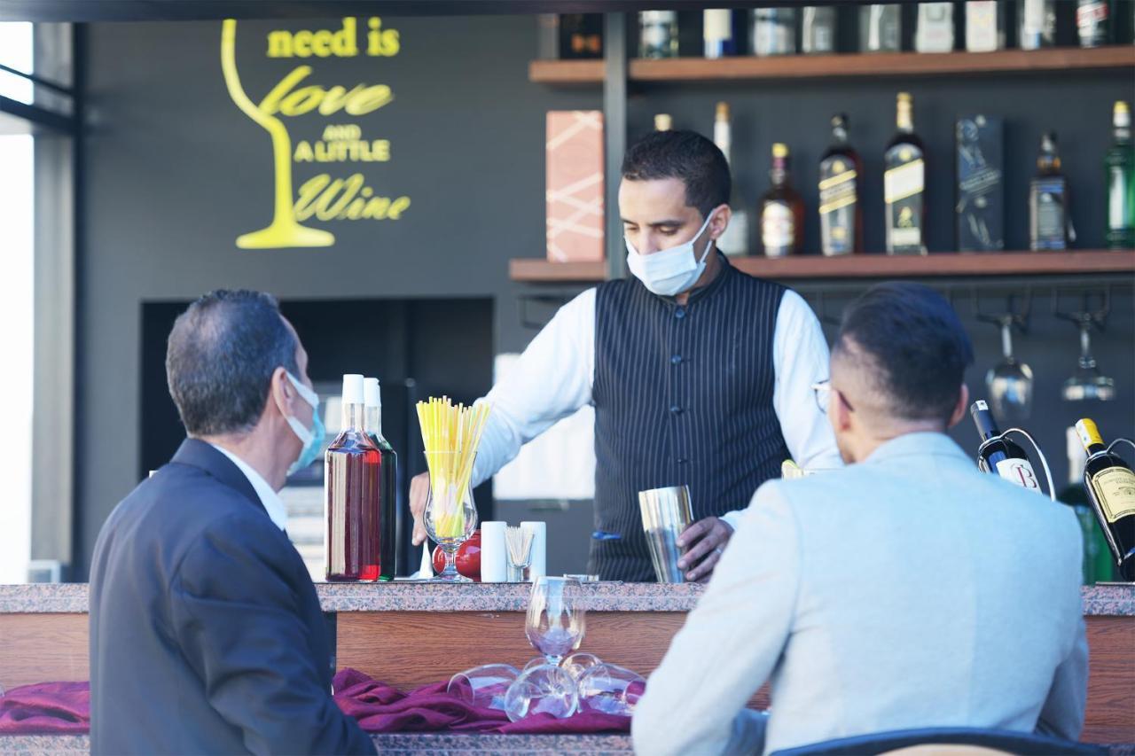 El Olivar Palace Marrakech El Harkat 외부 사진 A bartender wearing a face mask in Tirana, Albania